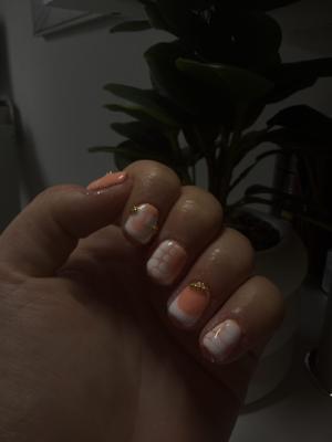 Soft peach french tips finished with fine gold glitter accents