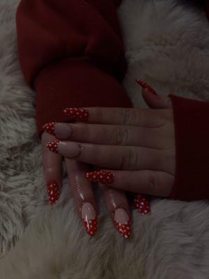 Long stiletto nails with red and white polka dot french tips