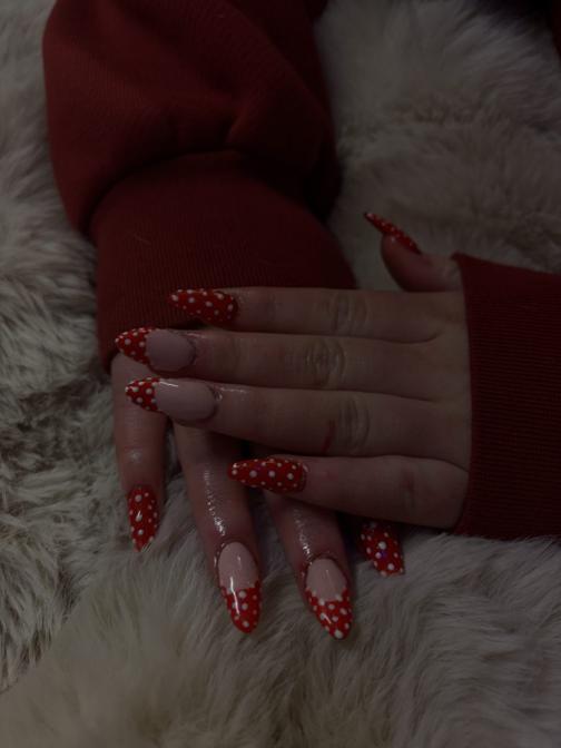 Long stiletto nails with red and white polka dot french tips