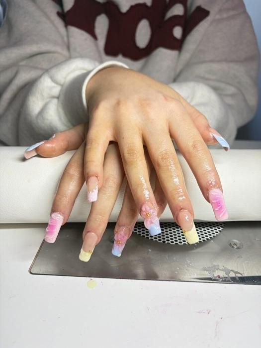 Long square nails in pastel pink, blue, and lemon marble with 3D flowers and gold beads