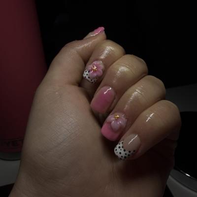 Pink nails with hand-painted 3D flowers and black dotted accents