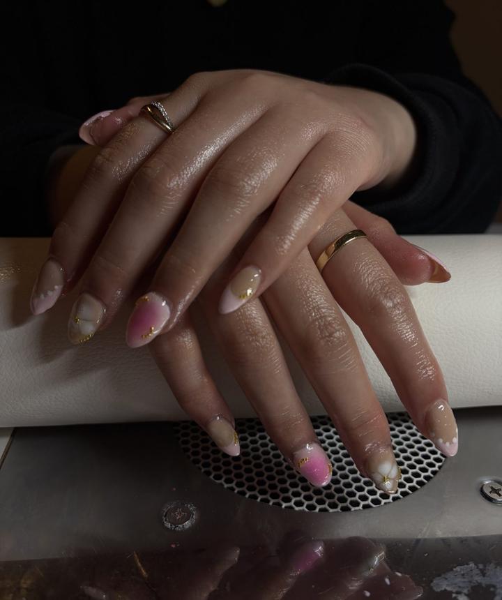 A finished set of pink and mauve marble nails flecked with gold