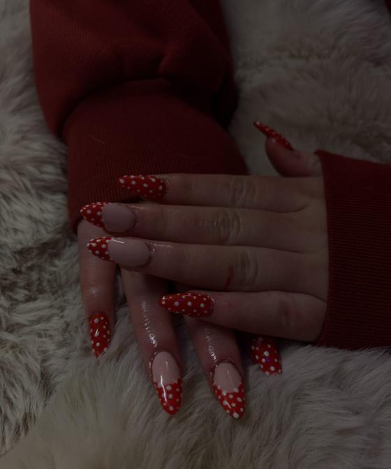 Long stiletto nails with red and white polka dot french tips